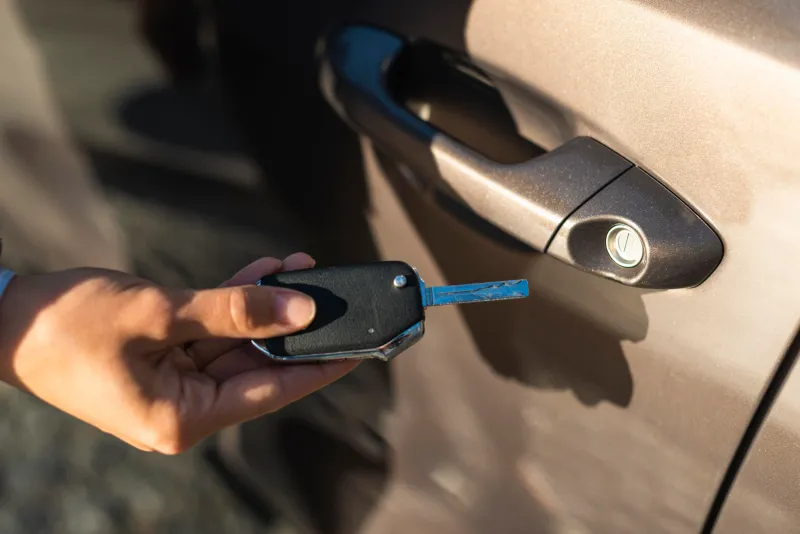 Auto locksmith unlocking a car during a lockout